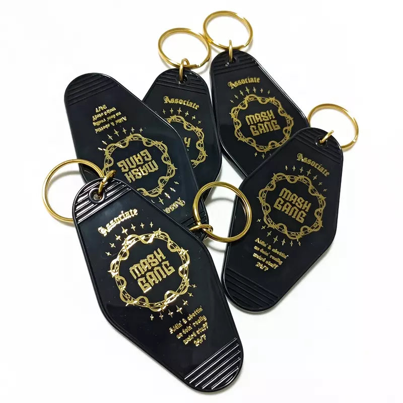 black or white custom motel keychain with gold lettering