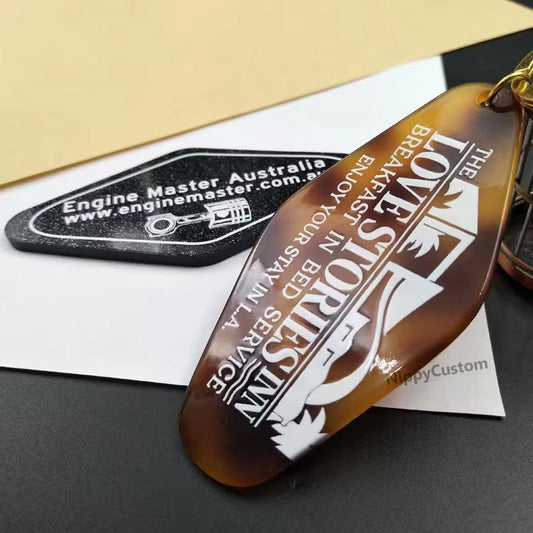 Personalized keychain with engraved text on a dark surface