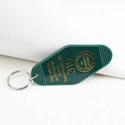 black or white custom motel keychain with gold lettering